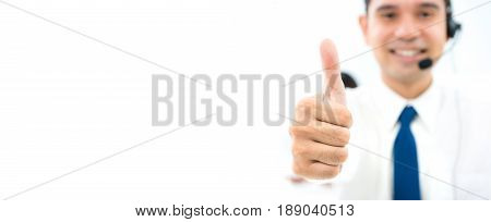 Male call center staff giving thumbs up - panoramic banner background with copy space