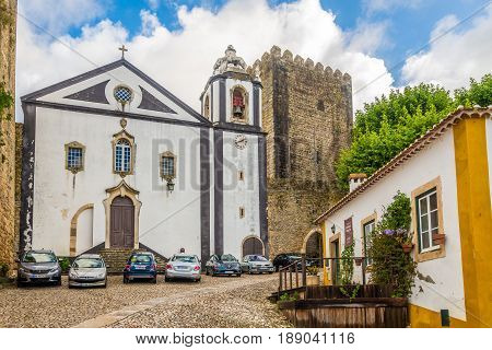 OBIDOS,PORTUGAL - MAY 11,2017 - View at the Santiago church in streets of Obidos. The area of the town of Obidos is located on a hilltop encircled by a fortified wall.