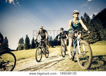 family of four cycling by the vilsalpsee in austria