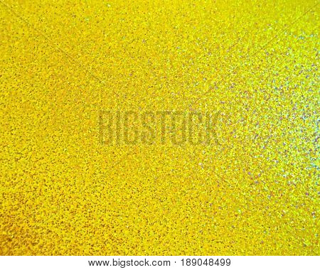 Multicolor rainbow glitter background in yellow tones