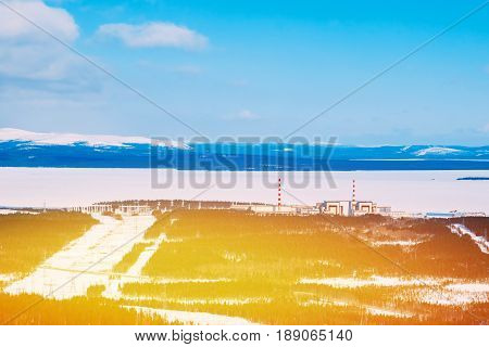Kola NPP  nuclear power station from the mountain. Industrial landscape. In the background are the mountains of Khibiny and Imandra lake.