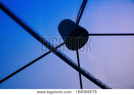 Television satellite dish is black color on the roof house.