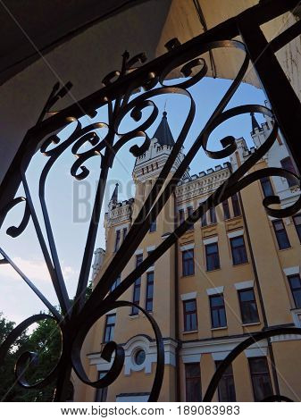 KIEV - UKRAINE - MAY, 2017: View of the Richard Castle on Andreevsky Spusk in Kiev. In the foreground, forged black gates. Vertical photo.