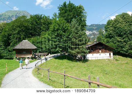 People Visiting On Walking Old Farm Houses In Ballenberg