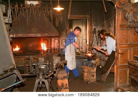 Two Blacksmith Working In The Smithy At Ballenberg