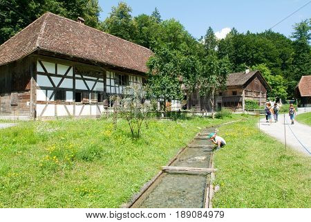 People Visiting On Walking Old Farm Houses In Ballenberg
