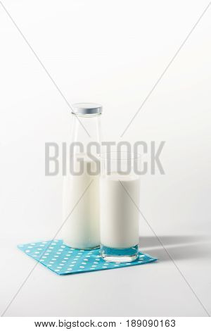 Milk In Glass And Bottle On Napkin With Copy Space Isolated On White