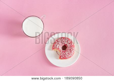 Top View Of Glass Cup Of Milk With Donut On Plate On Pink Background