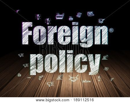 Politics concept: Glowing text Foreign Policy,  Hand Drawn Politics Icons in grunge dark room with Wooden Floor, black background