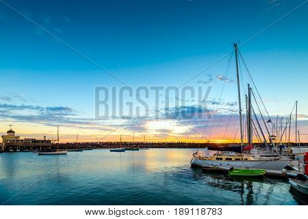 People gathered on St. Kilda Beach breakwaters to watch penguins' night show at sunset Victoria Australia