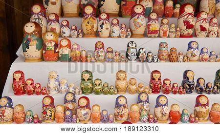 MOSCOW, MAY 26, 2017: Different colors Russian dolls matreshka at souvenir market shop. Traditional Russian handicraft hand made dolls. Famous classical and modern russian dolls matreshka toys