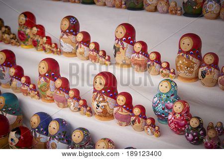 MOSCOW, MAY 26, 2017: Different colors Russian dolls matreshka at souvenir market shop. Traditional classic Russian handicraft art background. Famous classical and modern russian dolls matreshka toys