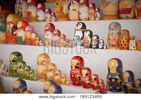MOSCOW, MAY 26, 2017: Different styles Russian dolls matreshka at souvenir market shop. Traditional Russian handicraft hand made dolls. Famous classic and modern russian dolls matreshka toys. Penguins
