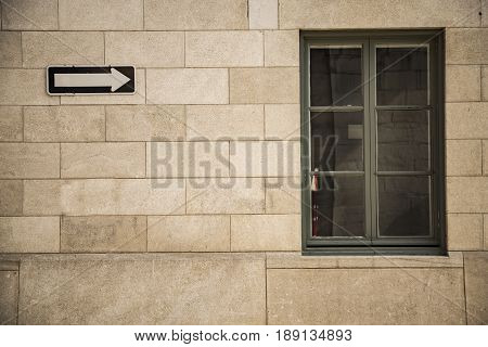 Red brick wall with a windowand raod sign in Canada