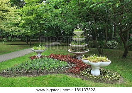 Vase decoration in the park, flowerbed,trees landscape