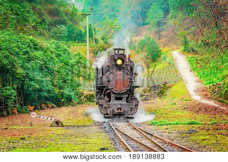 Steam narrow-gauge locomotive stands at the station on the way from Yuejin to Bagou. Jiayang Mining Region. Sichuan province. China