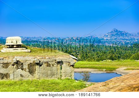 View from Hemakuta hill sunset point with ancient ruins Hampi, Karnataka, India. Landscape with unique mountain formation with amazing stones tropical nature and temple. UNESCO World Heritage Site