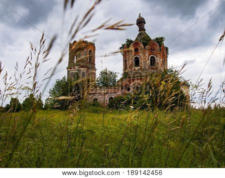 Old ruined church in the field. Blue sky