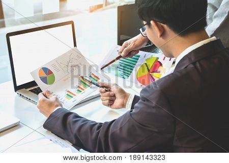 Two businessteam looking at report and having a discussion in office. business concept.