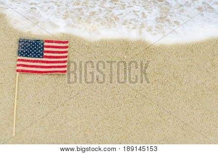 Patriotic USA background with american flag on the sandy beach