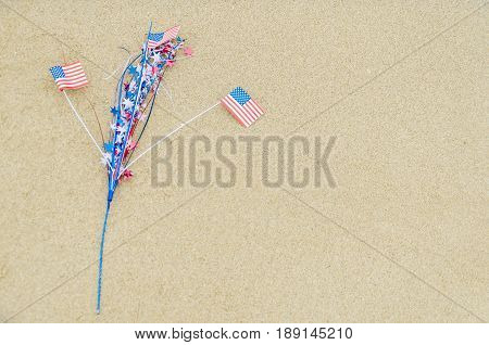 Patriotic USA background with flags and decorations on the sandy beach