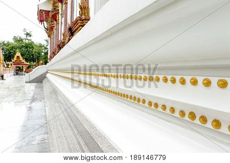 Yasothon Thailand - May 2017: Gold decoration around Ubosot (chapel) of Wat Mahathat Temple where Phra That Anon an old Thai chedi (stupa or pagoda) containing relic of Ananda (a favoured disciple of the Buddha) is located
