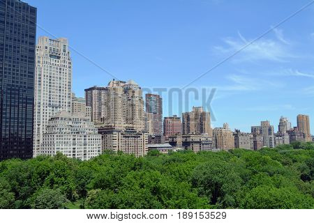Manhattan skyscrapers rise above trees in Central Park
