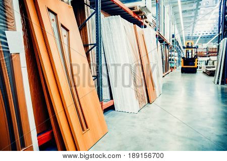 Warehouse of entrance and interior doors. Shelf with structural materials on the shelves in the construction warehouse. Concept logistics companies and large  warehouse industrial