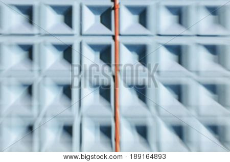 Abstract motion blur background of blue concrete wall with square cells geometrical pattern