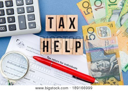 Tax Help - Australia - wooden letters with tax form, magnifying glass, money and calculator