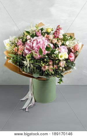 Still life with a bouquet of flowers. the florist put together a beautiful bunch of flowers. Man manual work used different types of flowers and colors.