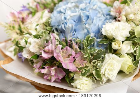 Still life with a bouquet of flowers. the florist put together a beautiful bunch of flowers. Man manual work used different types of flowers and colors.