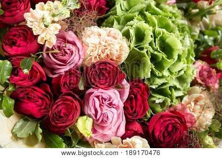 Still life with a bouquet of flowers. the florist put together a beautiful bunch of flowers. Man manual work used different types of flowers and colors.