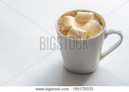 Cup Of Coffee with Marshmallows. White mug of hot drink with copy space background