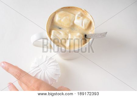 Cup Of Coffee with Marshmallows. White mug of hot drink with copy space background