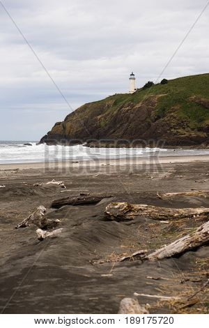 Vertical composition of beach below bluff that holds the North Head Lighthouse