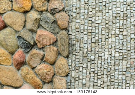 The junction of a cobblestone wall and a shallow mosaic. Wall with various finishes with natural stone. Mixed finishing wall