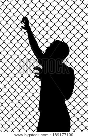 Silhouette Of Teenager Trying To Escape From Wired Enclosure