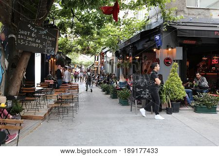 ISTANBUL TURKEY - MAY 28 2017: People have fun in cafes and bars in Karakoy district. Karakoy is the most popular destination for entertainment and travel of Istanbul