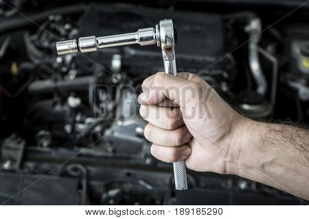 Car Mechanic Man At The Garage Fixing The Engine