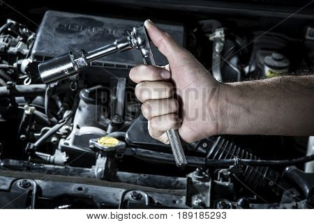 Car Mechanic Man At The Garage Fixing The Engine