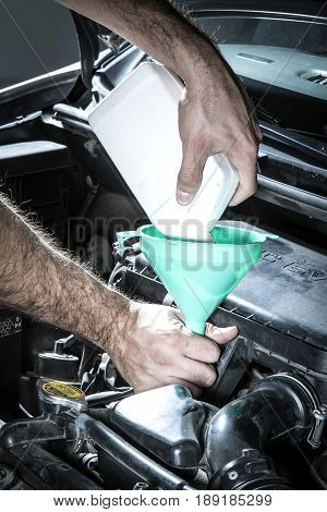 Car Mechanic Man At The Garage Fixing The Engine