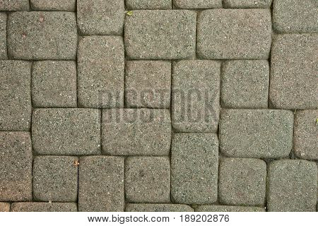 Stone pavement texture. Granite cobblestoned pavement background. Abstract background of old cobblestone pavement close-up. Seamless texture. Perfect tiled on all sides