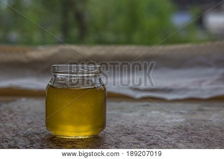 Honey In Jar And Window With Green On Backcground