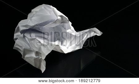 The garbage can recycle. White paper on the black mirror background