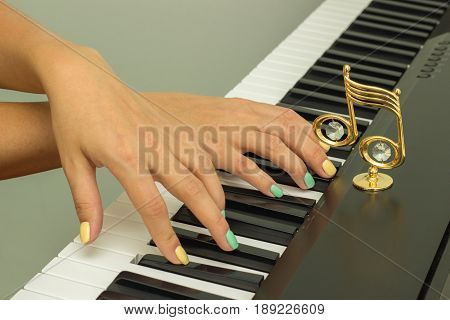 Beautiful female fingers playing electronic piano keyboards