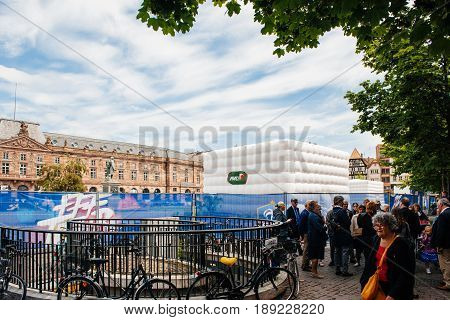STRASBOURG FRANCE - MAY 19 2016: Pedestrians looking at the FFF Tour Federation Francaise de Footaball installation in city center for the upcoming UEFA football soccer Championship