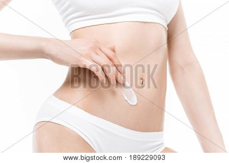 Cropped Shot Of Slim Young Woman In Underwear Applying Body Cream On Belly