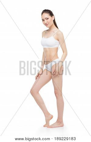 Sensual Young Asian Woman Posing In White Lingerie And Smiling At Camera
