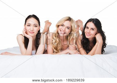 Young Beautiful Women Looking At Camera While Lying On Bed